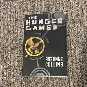The Hunger Games by Suzanne Collins - Black and Gold Cover Paper Back